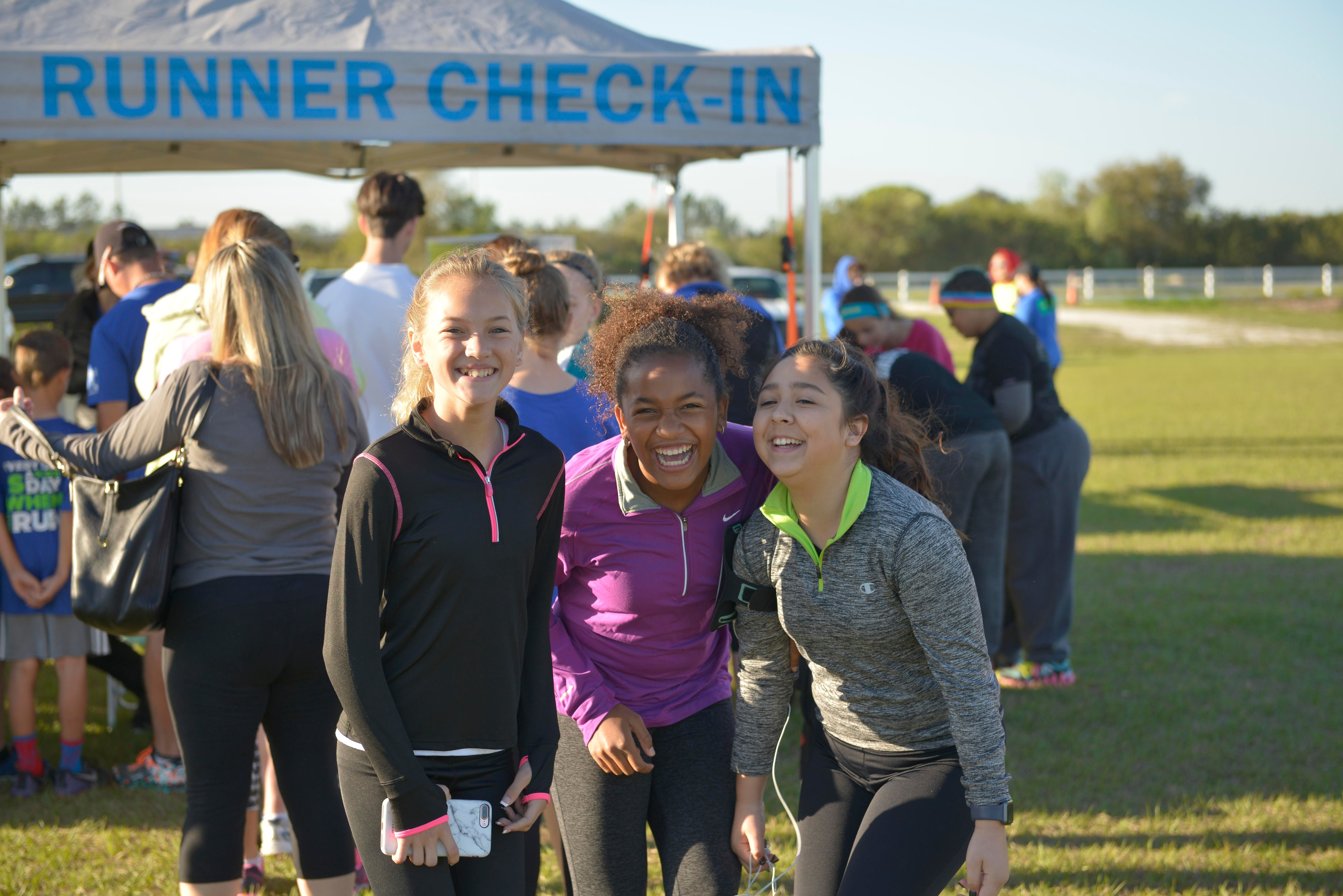 girl runners in front of check-in tent